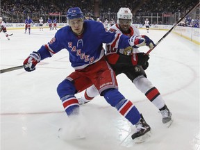 Brady Skjei #76 of the New York Rangers and Anthony Duclair #10 of the Ottawa Senators battle during the third period at Madison Square Garden on April 03, 2019 in New York City. The Senators defeated the Rangers 4-1.
