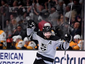 Drew Doughty #8 of the Los Angeles Kings celebrates an empty net goal from Dustin Brown #23, to take a 6-4 lead over the Nashville Predators, during a 7-4 win at Staples Center on October 12, 2019 in Los Angeles, California.