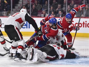 Phillip Danault of the Montreal Canadiens falls over goaltender Craig Anderson of the Ottawa Senators during the second period at the Bell Centre on Wednesday, Nov. 20, 2019.