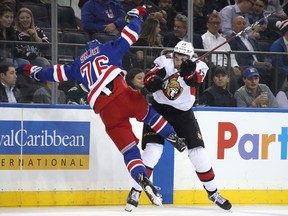 Brady Skjei of the Rangers takes a big hit from Nick Paul of the Senators during Monday's game at Madison Square Garden in New York.