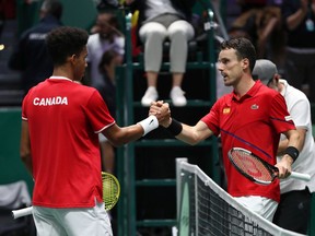 MADRID, SPAIN - NOVEMBER 24: Felix Auger-Aliassime of Canada (L) and Roberto Bautista Agut of Spain (R) shake hands following their singles final match during Day Seven of the 2019 Davis Cup at La Caja Magica on November 24, 2019 in Madrid, Spain.