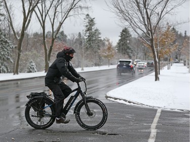A cyclist bikes through the Experimental Farm during Ottawa's first snowfall, November 07, 2019.