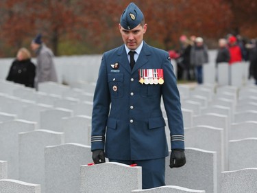 A soldier stands in respect at the National Military Cemetery after the Remembrance Day Ceremony, November 11, 2019.