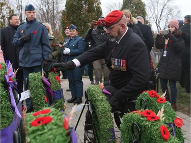 A soldier lays his poppy on a wreath after the  Remembrance Day Ceremony at the National Military Cemetery, November 11, 2019.