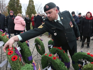 Sgt. Brad Plowright lays his poppy on a wreath after the  Remembrance Day Ceremony at the National Military Cemetery, November 11, 2019.