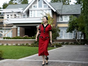 Meng Wanzhou, chief financial officer of Huawei Technologies Co., leaves her home for a court appearance wearing an electronic ankle tag in Vancouver, British Columbia, Canada, on Tuesday, Oct. 1, 2019.