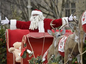 File photo/ Santa Claus waves to the crowd during the Help Santa Toy Parade in Ottawa on Saturday, Nov. 22, 2014.