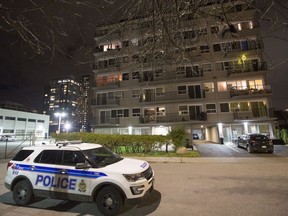 An Ottawa Police Service vehicle sits outside the Sidney Towers apartment building on Sidney Street on Friday evening.