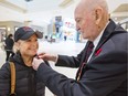 Second World War Art Boudreau, who turns 100 in February, pins a poppy on Shelley Kettles at Bayshore Shopping Centre.