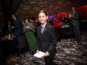 Ten-year-old Logan Hussein makes his way to the stage to accept his award, the Outstanding Youth Philanthropist Award.