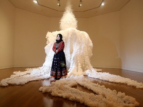 Eleng Luluan, from the Rukai Nation in Taiwan, poses in front of her installation made from styrofoam and wrapping bags entitled "Between Dreams."