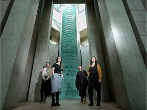 The artists from New Zealand's Mato Aho Collective stand in front of their monumental woven installation titled "AKA, 2019."