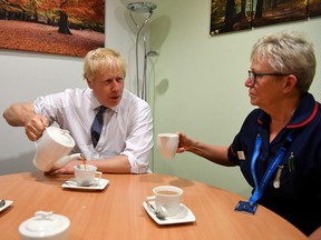 Britain's Prime Minister Boris Johnson pours tea as he talks with nursing staff during a general election campaign visit to King's Mill NHS Hospital in Mansfield, Britain November 8, 2019.