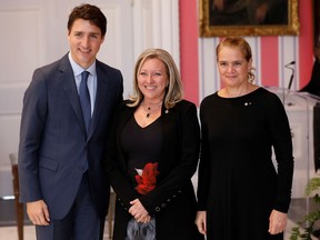 Mona Fortier, centre, poses with Prime Minister Justin Trudeau and Gov. Gen. Julie Payette after being sworn-in as Minister of Middle Class Prosperity and Associate Minister of Finance on Nov. 20. At least her title describes her job.