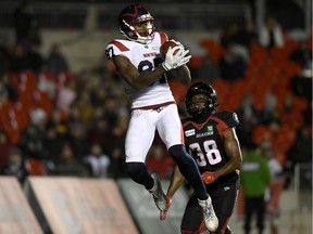 Montreal Alouettes wide receiver Eugene Lewis catches the ball for a touchdown in front of Ottawa Redblacks defensive back Brandin Dandridge during first- half CFL football at TD Place stadium on Friday, Nov. 1, 2019.
