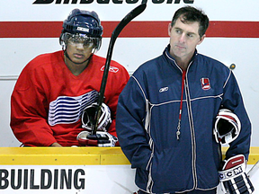 Windsor Spitfire rookie Akim Aliu and coach Moe Mantha in October 2005, shortly before Mantha was suspended for 40 games over a hazing incident involving Aliu.