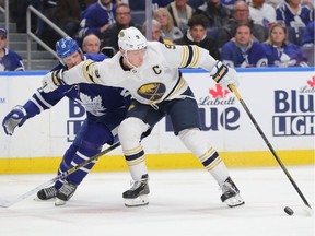 Buffalo Sabres centre Jack Eichel (9) skates by Toronto Maple Leafs centre Jason Spezza (19) with the puck during the second period at KeyBank Center.