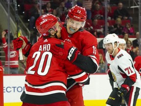 Hurricanes winger Warren Foegele (13) is congratulated by teammate Sebastian Aho after scoring first-period goal on Monday night. Senators forward Chris Tierney is in the background.