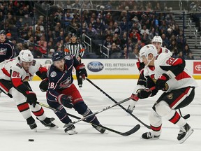 Senators defencemen Nikita Zaitsev, right, and Ron Hainsey, left, try to cut off Blue Jackets winger Oliver Bjorkstrand during the second period of Monday's contest.
