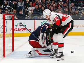 The puck bounces away after Blue Jackets goalie Joonas Korpisalo makes a save on a breakaway attempt by the Senators' Connor Brown during the third period of Monday's game.