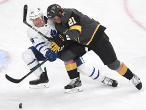Nov 19, 2019; Las Vegas, NV, USA; Toronto Maple Leafs defenseman Tyson Barrie (94) sweeps the puck away from Vegas Golden Knights center Cody Eakin (21) during the first period at T-Mobile Arena.