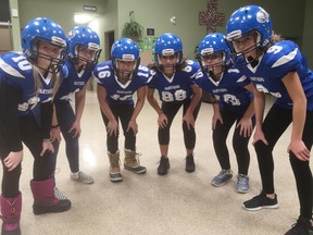 From left: Zoe Thompson, Emma Ouellet, Mia Tasoulis, Michelle Garrison, Mya Sluban and Sophie Franche huddle in anticipation of the first girls-only tackle football program in Ottawa, which is being organized by the Cumberland Panthers football club.  Martin Cleary/photo
