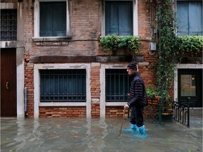 A man walks outside during exceptionally high water levels in Venice, Italy November 13, 2019. REUTERS/Manuel Silvestri ORG XMIT: GGG-MSL131