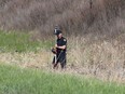 Ontario Provincial Police traffic accident reconstructionists investigate the scene of a three vehicle crash that killed four people and seriously injured two others overnight Thursday May 11 2017 on Hwy. 401 westbound lanes just west of Joyceville Road, east of Kingston. Ian MacAlpine /The Whig-Standard/Postmedia Network