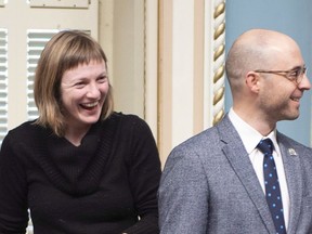 Quebec Solidaire MNAs Catherine Dorion, left, and Sol Zanetti smile as they enter for question period at the legislature in Quebec City on December 5, 2018.