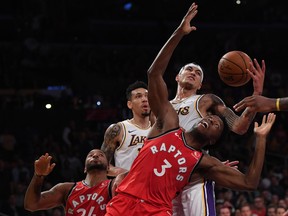 Raptors’ OG Anunoby and Lakers’ Kyle Kuzma go for a rebound as Raps’ Norman Powell and Lakers’ Danny Green close in during Sunday’s game. Anunoby departed Monday’s game against the Clippers early with an eye injury. (GETTY IMAGES)