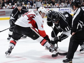 Jean-Gabriel Pageau #44 of the Ottawa Senators faces off against Anze Kopitar #11 of the Los Angeles Kings at STAPLES Center on February 26, 2015 in Los Angeles, California.