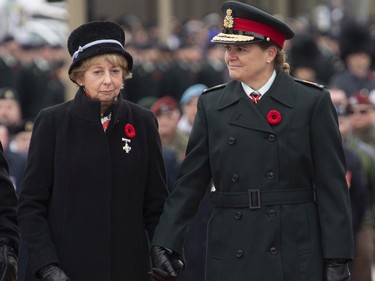 Governor General Julie Payette holds the hand of Silver Cross Mother Reine Samson Dawe after she placed a wreath during the Remembrance day ceremony at the National War Memorial Monday November 11, 2019 in Ottawa.