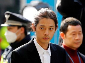 FILE PHOTO: South Korean singer Jung Joon-young arrives for questioning on accusations of illicitly taping and sharing sex videos on social media, at the Seoul Metropolitan Police Agency in Seoul, South Korea, March 14, 2019.