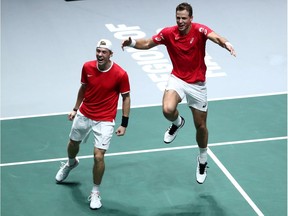 Canada's Vasek Pospisil and Denis Shapovalov celebrate after winning their doubles match against Russia's Karen Khachanov and Andrey Rublev.