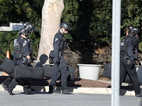 Members of U.S. Secret Service counter assault team carry their gear as President Donald Trump arrives at Walter Reed National Military Medical Center in Bethesda, Maryland,