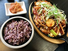 Sizzling spicy squid, purple rice and kimchi at Maht