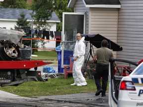 Police investigate at the scene of a fire in Gatineau's Buckingham district, Quebec on Saturday, August 31, 2019.