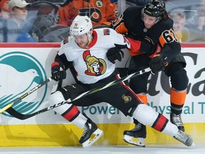 Chris Tierney of the Senators is checked by Justin Braun of the Flyers in the first period of Saturday's game in Philadelphia.