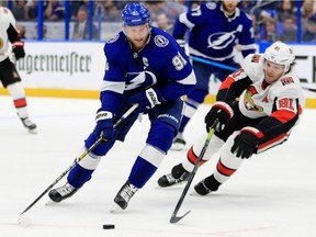 Ron Hainsey of the Senators tries to cut off Steven Stamkos of the Lightning as he drives toward the goal during Tuesday's game at Amalie Arena in Tampa, Fla.