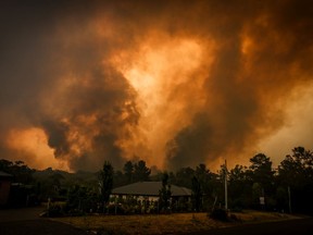 Two bushfires approach a home located on the outskirts of the town of Bargo on December 21, 2019 in Sydney, Australia.