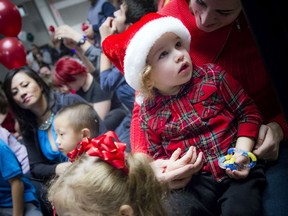 Two-year-old Dax MacDonald had his festive hat on while keeping a close eye on Santa at Jake's House Holiday Party at the Infinity Centre.