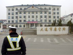 A Chinese police officer stands outside a prison in Dalian in northeastern China's Liaoning Province.