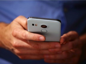 SAN FRANCISCO, CA - SEPTEMBER 29:  An attendee inspects the new Nexus 5X phone during a Google media event on September 29, 2015 in San Francisco, California. Google unveiled its 2015 smartphone lineup, the Nexus 5x and Nexus 6P, the new Chromecast and new Android 6.0 Marshmallow software features.  (Photo by Justin Sullivan/Getty Images)