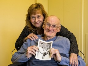 Donna Bertrand and her father Charles Diffin pose for a photo as Charles holds a wedding photo of his wife Joan. October 22, 2019.