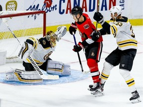 Boston Bruins Zdeno Chara checks Ottawa Senators Brady Tkachuk in front of goaltender Tuukka Rask during NHL action at the Canadian Tire Centre on Nov. 27, 2019.