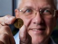 Steve Woodland, president of the Ottawa Numismatic Society, holds a 1943 Canadian five-cent coin. Because of the Second World War, the five cents was made Tombac, a brass alloy of copper and tin, to conserve supplies of nickel.
