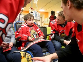 Jacob Choueiri, 9, who suffers from leukemia, was thrilled to meet some of his hockey heroes Thursday during the visit, including, from left, Cody Goloubef, Brady Tkachuk, and Thomas Chabot during the Ottawa Senators' their annual Christmas visit to CHEO.
