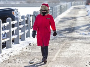A pedestrian is bundled up while walking along the canal at Fifth Avenue.