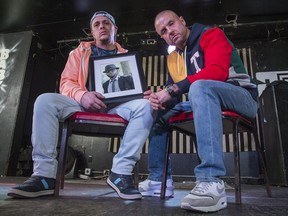 Christopher "Ironic" Wiens and William "Memo" Moreno of HalfSizeGiant  photographed holding a photo of Markland Campbell, their groupmate, who was gunned down in the ByWard Market in June.