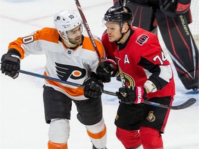 Senators defenceman Mark Borowiecki battles for position against the Flyers' Andy Andreoff during the first period of Saturday night's game.